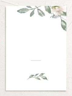 a white card with green leaves and flowers on the front, which is blank for text