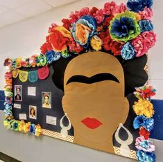 a bulletin board with flowers on it and an african woman's face in the center