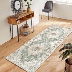 a living room area with a rug, chair and potted plant on the floor