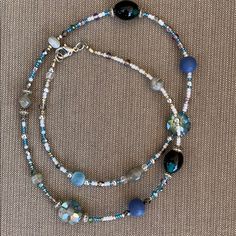 Handmade By Me; Bead Necklace In Blue, Silver, White And Gray Beads. Two Larger Green/Black Stones. Necklace Is Accented With Silver Pieces. Necklace Is 23” Long. Would Look Beautiful Layered With A Smaller Necklace. One Of A Kind.