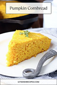 a slice of pumpkin cornbread on a white plate with a fork next to it