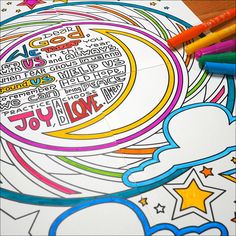 a coloring page with colorful writing on it and some crayons next to it