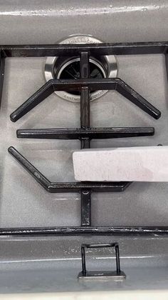 a stove top with two burners and a spatula on the bottom one side