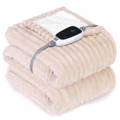 two blankets stacked on top of each other with an electric heated blanket plugged in