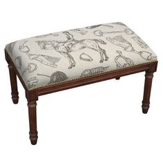 an upholstered foot stool with horse and rider prints on the fabric, sitting in front of a white background