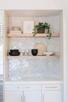 the shelves in this kitchen are filled with dishes