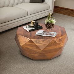 a living room with a couch, coffee table and book on the floor in front of it