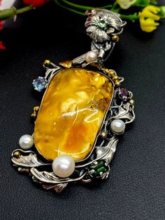 "ARTISAN AMBER GEMSTONE PENDANT Hand-made Sterling Silver 925. 24k Gold Stones used: Butterscotch Baltic Amber Pink&Green Tourmaline, Pearls Height - 2 3/4' (with bail), Width - 1 3/8' Height -70mm (with bail), Width - 35mm Unique Handcrafted One-of a-kind Design Pendant Each Piece of Jewelry in my Collection is Absolutely One of a Kind! When you start wearing a piece of my jewelry you will fall in love with it more and more each day and feel that good Energy and Love that I pass into it whi Luxury Citrine Cabochon Jewelry, Yellow Polished Pendant Jewelry, Yellow Pendant Jewelry With Polished Finish, Luxury Amber Jewelry With Polished Finish, Luxury Citrine Jewelry For Gifts, Luxury Yellow Multi-stone Jewelry, Luxury Cabochon Jewelry As Gift, Luxury Cabochon Jewelry For Gift, Elegant Yellow Cabochon Necklace