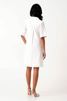 White woven shirt dress with floral bird motif embroidery and placement thread work. - Aza Fashions White V-neck Shirt Dress For Work, Elegant Cotton Embroidered Day Dress, Floral Embroidery Midi Dress For Daywear, Floral Embroidered Midi Dress For Daywear, Elegant Cotton Embroidered Short Sleeve Dress, Chic Embroidered Dress For Daywear, Elegant Short Sleeve Embroidered Cotton Dress, White V-neck Relaxed Fit Shirt Dress, White Relaxed Fit V-neck Shirt Dress