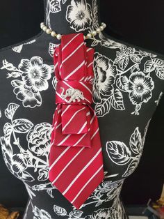 This Red and Whit Stripe Necktie Necklace is made with woven silk, and features a  Rhinestone Elephant Brooch strung on your choice of an adjustable Rosary Chain Ribbon Tie Pearl Necklace or an adjustable Elastic Band. The soft, comfortable fabric sits perfectly on any size chest, while the adjustable necklace feature allows you to customize the fit to your liking. Measuring at a versatile length, this necktie necklace is designed to be a one-size-fits-all. View all Women Tie's: https://www.etsy Neck Tie Necklace Diy, Elegant Adjustable Neckwear For Gifts, Elegant Adjustable Neckwear As Gift, Elegant Adjustable Neckwear As A Gift, Luxury Tie For Gift, Elegant Red Neckwear For Gift, Elegant Red Neckwear As A Gift, Luxury Standard Tie For Gift, Luxury Gift Tie