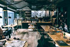 the inside of a restaurant with wooden tables and chairs