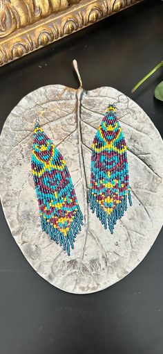 "These earrings are fun and funky! They pack a punch in bold colours of teal, blue, purple, pink and yellow. They are made with lightweight delica beads so they're easy on your ears. The hook is silver in colour and is hypoallergenic and nickel free.  They are 5\" long including the hook and 1\" wide. Handmade with love and ready to ship! Follow me on Instagram @silvermoonmacrame!" Meditation Bracelet, Mala Bracelet, Chakra Bracelet, Delica Beads, Silver Moon, Pink And Yellow, Seed Bead Earrings, Seed Bead Jewelry, Fringe Earrings