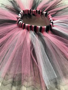 This listing is for a pink, black, and white tutu.  Colors and sizes can be customized to fit your needs. If you would like a shorter length, please specify when you order. If you need a longer skirt, please send me a custom order request before you purchase. A bow can be added to the tutu at no additional cost. I have plenty of ribbon colors, just let me know what color you would like in your order notes if the color is not listed on the dropdown menu! Size Chart Infant (0-18 months) - fits 14-18" waist - 6" length  Toddler (2T-4T) - fits 18-24" waist - 8" length Young Girls (5T-10) - fits 22-28" waist - 10"length Older Girls (12-16) - fits 26-34" waist - 12" length Adult XS-S-M - fits 30-40" Waist - 14" Length Adult L-XL-XXL - 38-48" Waist - 14" Length Please take careful measurements be Black And White Birthday, Handmade Tutu, Girls Costumes, White Tutu, Rose Noir, White Birthday, Baby Tutu, Langer Rock, Birthday Tutu