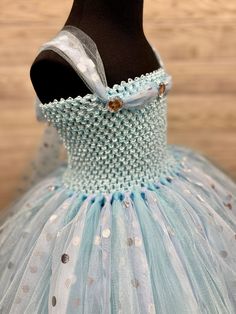 Fuzzy Duckling Design dresses ~ handcrafted for the little princess in your life. Our beautiful dresses feature a stretchy, crocheted bodice that is fully lined for both comfort and modesty. The full skirts sparkle and shine with three layers of high quality tulle in matte, shimmer, and an extra-special silver foil polka dot finish. So beautiful! Our standard dresses are designed to be tea-length and should reach to approximately mid-calf on your little princess. If your little one is slightly s Blue Ruffled Princess Dress For First Birthday, Fitted Light Blue Princess Dress For Birthday, Polka Dot Princess Dress For Party, Princess Style Polka Dot Party Dress, Whimsical Blue Dress For Birthday, Blue Tulle Dress For First Birthday, Blue Sleeveless Dress For First Birthday, Blue Princess Dress For First Birthday, Blue Fitted Dress For First Birthday