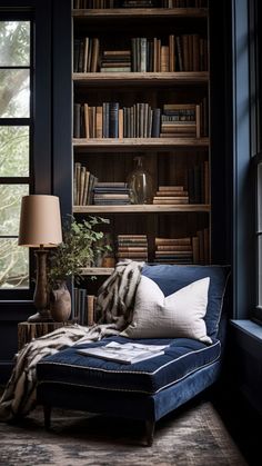 a blue chaise lounge chair in front of a bookshelf