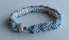 the beaded bracelet is made with silver and blue beads