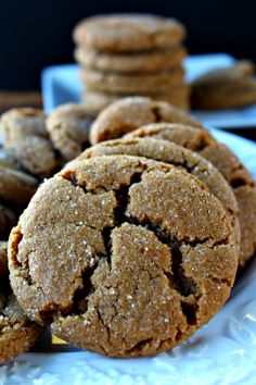 several cookies are stacked on a white plate