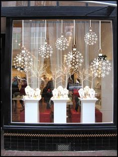 a store window with snowflakes on the windowsill