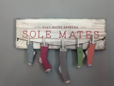 some socks hanging on a clothes line with the words sole mates written above them in red, green, and blue