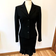 Le Suit- Black And White Pin Strip Skirt Suit. Three Button Down Blazer Suit Jacket And Matching Skirt With Ruffle Hem Line That Zips In The Back. This Suit Is Absolutely Beautiful And In Excellent Brand New Condition. Pet Free And Smoke Free Home Size 6 Measurements: Blazer- Shoulder To Sleeve Hem: 24 Inches Skirt - Waistline Width: 14 1/2 Inches Length: 25 Inches Black Fitted Long Sleeve Skirt Suit, Black Fitted Skirt Suit For Office, Fitted Black Skirt Suit For Office, Fitted Black Skirt Suit For Business, Elegant Fitted Black Skirt Suit, Fitted Blazer With Buttons For Office Lady, Fitted Office Lady Blazer With Buttons, Formal Fitted Single Button Skirt Suit, Fitted Single Button Skirt Suit For Formal