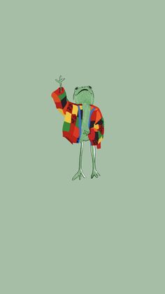 a green frog holding a red, yellow, and blue kite in it's arms