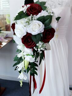 a bridal bouquet with red and white flowers