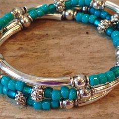 "This Stunning Bohemian Style Bracelet will be noticed and adored! It's made to wrap around your wrist three times and connects with a lobster clasp. It has an extension chain to adjust to a tight or loose fit. Beautiful, high quality turquoise glass Czech seed beads, silver tube beads and Silver Tibetan beads are through out. This bracelet can be worn in every season, dressed up or down! This stunning bracelet can also be worn as a beautiful and unique necklace! You can choose your own symbolic Bohemian Turquoise Beaded Bracelets With Silver Beads, Bohemian Turquoise Beaded Bracelet With Silver Beads, Adjustable Turquoise Stretch Bracelet With Silver Beads, Turquoise Beaded Bracelets With Silver Beads, Turquoise Stretch Bracelet With Silver Beads, Bead Wrap Bracelet, Black Turquoise, Beaded Wrap Bracelets, Turquoise Glass