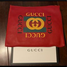 A Pouch Makes For A Great Travel Accessory. This Gucci Pouch Is Crafted From Red Leather And Styled With The Logo On The Front. The Zip Top Closure Opens. Designer Leather Pouch For Gifts, Gucci Designer Wallets With Logo, Designer Gucci Wallets With Logo, Designer Shopping Clutch Pouch, Designer Pouch Clutch For Shopping, Luxury Gucci Wallet With Logo, Designer Clutch Pouch For Shopping, Gucci Red Bag With Removable Pouch, Chic Gucci Leather Clutch