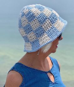 Step into summer with the Coastal Dreams Crochet Bucket Hat, a blend of baby blue and off white that captures the essence of beachside relaxation and boho chic style. Inspired by the carefree vibes of the Y2K era, this handmade crochet cotton hat is not just a stylish accessory, but a practical one too, offering protection from the sun while you sip cold coffee on a patio or lounge by the dock at your cottage. Crafted with love and attention to detail, each hat is made from high-quality cotton, Fall Poncho, Hat Y2k, White Bucket Hat, Bucket Hat Summer, Boho Hat, Crochet Bucket, Crochet Bucket Hat, Hat Handmade, Cold Coffee