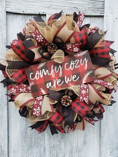 a red and black wreath with the words country are we on it hanging on a wooden door