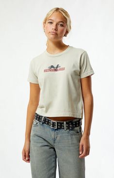 The Hollywood LA Dreams Eagle T-Shirt from PS / LA is your go-to for a chic, casual look. Featuring short sleeves and a crew neckline, it has a slightly cropped length with a relaxed boxy fit. Bold Hollywood Los Angeles eagle graphics adorn the front and back, adding a touch of standout style.Solid color teeShort sleevesCrew necklineFront & back graphicsSlightly cropped lengthRelaxed boxy fit100% cottonMachine washableModel is wearing a size smallModel measurements: 5’7.5” height, 32” bust, 24” waist, 35” hips PS / LA Womens Hollywood LA Dreams Eagle T-Shirt - Brown size XS Trendy Cropped Crew Neck T-shirt With Logo, Graphic Print Crew Neck Short Sleeve Top, Casual Short Sleeve Crew Neck Top With Graphic Print, Short Sleeve Cropped T-shirt With Text Print, Everyday Logo Print Crew Neck Tops, Casual Fitted Short Sleeve Top With Graphic Print, Fitted Casual Short Sleeve Top With Graphic Print, Summer Crew Neck Cropped T-shirt With Logo Print, Short Sleeve Cropped T-shirt With Screen Print