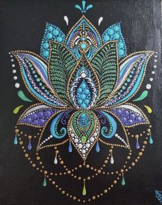 a painting on a black board with blue and green designs