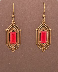 Ruby Red Crystal Art Deco Earrings have an antique brass base which is a metal stamping with hollow back. Centered large rectangular vintage crystal chaton with gold back. Earrings dangle from antique brass tone ear wires. These are Takeen Arts original and one-of-a-kind (OOAK). Designed and created by TLP and staff for Takeen Arts. Item E841. Vintage Red Brass Earrings, Vintage Rectangular Metal Earrings, Art Deco Red Rectangular Jewelry, Red Rectangular Art Deco Jewelry, Formal Red Brass Earrings, Red Art Deco, Deco Earrings, Red Art, Art Deco Earrings