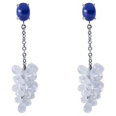 Alex Jona design collection, hand crafted in Italy, beautiful Clusters of natural cabochon Moonstone drops weighing 22 carats, dangling from two oval cabochon Tanzanites weighing 3.59 carats in total, mounted in 18k white gold. Length 1.7in.-43mm, Width 0.39in.-10mm. Posts with friction backs for pierced ears. Alex Jona jewels stand out, not only for their special design and for the excellent quality of the gemstones, but also for the careful attention given to details during all the manufacturi