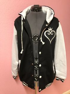 "Simple and Clean. Kingdom Hearts inspired varsity style hoodie jacket. Polyester Fleece backed, very similar to a LIGHT WEIGHT sweatshirt. Two functioning front pockets, button snap front and drawstring hood. This Jacket has a light stretch for comfort and fit. PLEASE CHECK THIS SIZE CHART for your size **SIZES OF JACKETS ARE CLOSE TO YOUR FITTED T-SHIRT SIZE** Small: Max 37\" chest, Length 22.5\" long, Sleeves 22.5\" long, Shoulders 15\". Medium: Max 40\" chest, Length 23.5\" long, Sleeves 23. Kingdom Hearts Jacket, Video Game Outfits, Gaming Hoodie, Heart Clothes, Kingdom Hearts 3, Varsity Style, Anime Clothes, Heart Hoodie, Style Hoodie