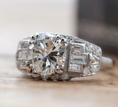 an old - fashioned diamond ring sits on a table