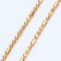 a gold chain is shown on a white background with no people in the photo or description