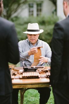 a man sitting at a table holding a piece of paper