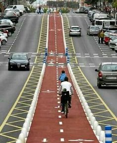 a bicyclist is riding down the street in traffic