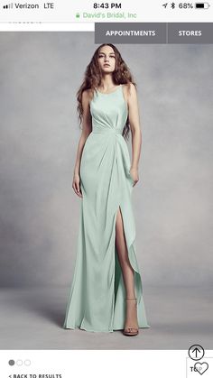 a woman in a blue dress is standing on a gray background with the words david's bridal