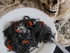 a white plate topped with spaghetti and skulls