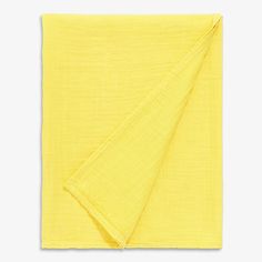 a yellow napkin folded on top of a white surface