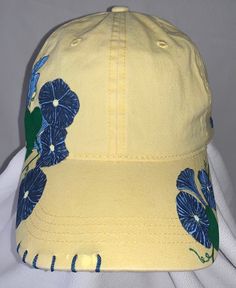 "Good Morning, Glory" women's adjustable ball cap shown in yellow. This baseball cap features beautiful clusters of morning glories that have been wood burned, and then precision dyed and painted by hand. The unique stitching and handmade charm make this cap a must-have for all the morning people out there. Available in yellow (shown), lavender, pink and white. Please note that charms may vary from what is shown depending on supply. ALL designs are fully customizable; Personal color options may be made-to-order. Custom orders can take up to two weeks to create.  Email SouthernSunshineCustoms@gmail.com with any questions, or to discuss custom order options.  Return Policy We will accept returns of item if notified within 14 days. Buyer to pay all costs associated with return shipping. Funds Yellow Cotton Trucker Hat With Curved Brim, Yellow Cotton Trucker Hat, Yellow Dad Hat For Summer, Yellow Dad Hat Baseball Cap For Summer, Yellow Baseball Cap Dad Hat, Yellow Baseball Cap With Curved Brim, Yellow Trucker Hat Baseball Cap For Spring, Yellow Snapback Dad Hat For Spring, Yellow Adjustable Trucker Hat