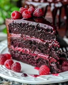 a slice of chocolate cake with raspberries on top