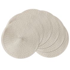 four round placemats in white on a white background with no one around them