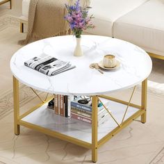 a living room with a white couch and coffee table in the middle, surrounded by books