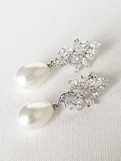 "Pearl Wedding Earrings Lovely classic pearl drop earrings for the bride. Cubic zirconias set in a silver setting with a light cream faux pearl. Very light weight and easy to wear with posts for pierced ears only. Also available in rose gold color at this time. ♥ DETAILS: Pearl Drops, Cubic Zirconia stones ♥ SIZE: Earrings measure 1 3/8\" in length ♥ COLOR: Silver or Rose Gold finish with light cream pearls (Only 1 pair of rose gold left) ♥PRODUCTION TIME: Ready to ship ♥ Please be sure to read Classic Silver Bridal Earrings For Formal Occasions, White Cubic Zirconia Diamond Earrings For Wedding, Classic White Drop Chandelier Earrings, Sparkling Pearl Earrings For Wedding, Classic Cubic Zirconia Chandelier Earrings For Anniversary, Elegant Pearl Drop Earrings For Wedding, Pearl Bridal Earrings In Diamond White For Anniversary, Diamond White Pearl Bridal Earrings For Anniversary, White Sparkling Diamond Earrings For Wedding