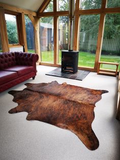 a living room with two couches and a cowhide rug