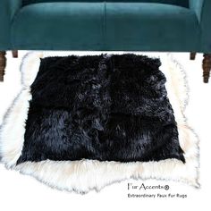 a green velvet couch with black and white fur on the floor next to a blue chair