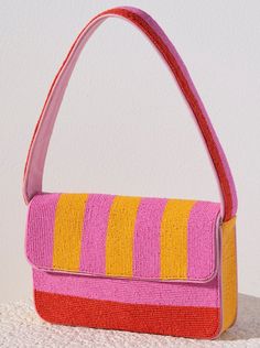 Everyday outfits just got more elegant with Shiraleah's Taylor Shoulder Bag. With its classic baguette silhouette, the purse's exterior is composed entirely of carefully embroidered glass beads. Its vibrant pink, orange, and yellow stripe design will give every outfit an extra pop of color. Pair with other items from Shiraleah to complete your look! Summer Evening Baguette Bag In Rectangular Shape, Summer Evening Rectangular Baguette Bag, Elegant Pink Rectangular Baguette Bag, Elegant Pink Baguette Bag For Party, Rectangular Summer Bags With Colorful Beads, Pink Rectangular Baguette Bag For Evening, Pink Rectangular Evening Baguette Bag, Summer Pink Beaded Bag, Summer Pink Beaded Shoulder Bag